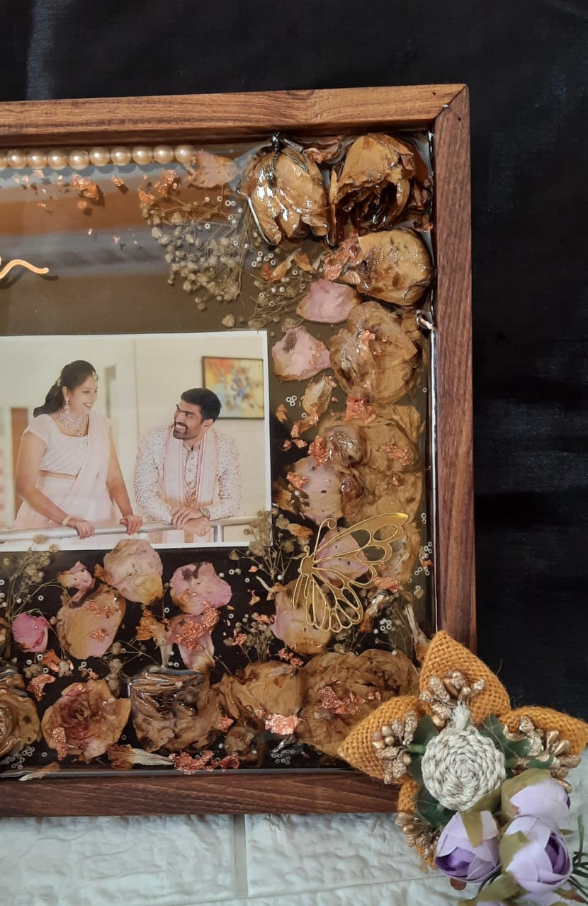 Eternal Bonds: Preserved Varmala Flowers in a Timeless Wooden Frame with Couples' Pictures