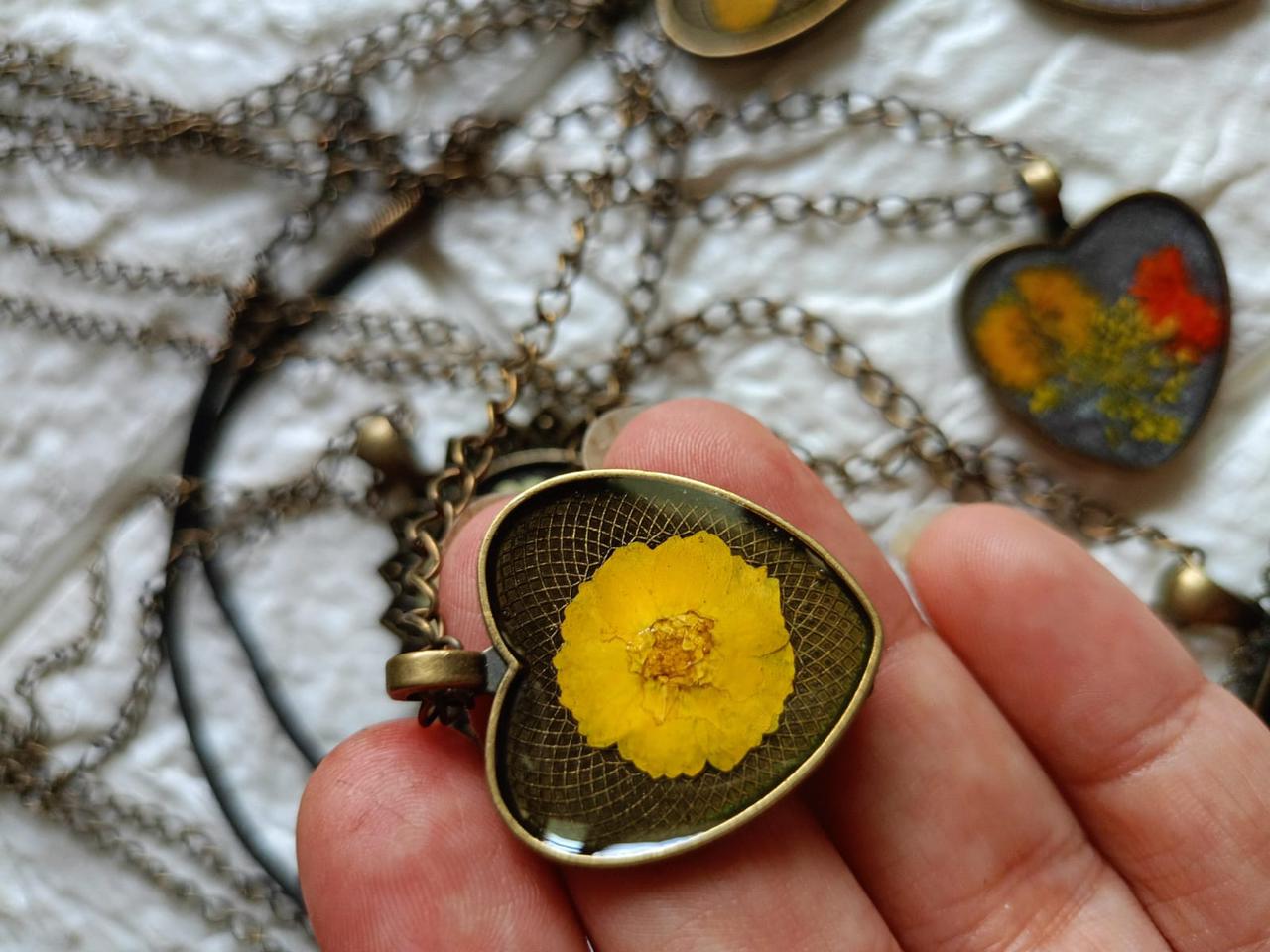 Resin Heart Shaped Pendant Yellow Flower Inclusion